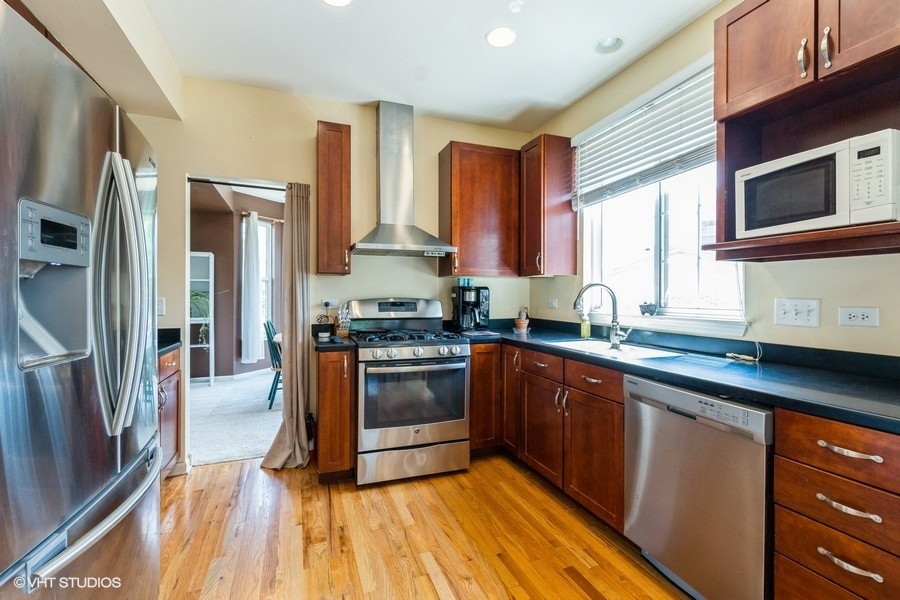 9675 Newton Road Huntley, IL 60142 - Photo 5 of 18 a kitchen with stainless steel appliances granite countertop a stove a sink and a refrigerator