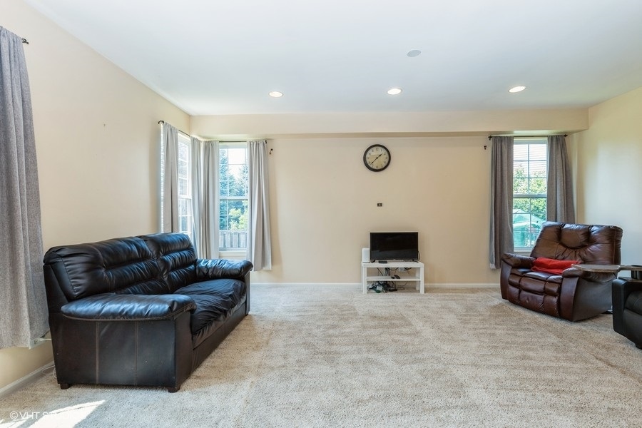 9675 Newton Road Huntley, IL 60142 - Photo 7 of 18 a living room with furniture and a fireplace