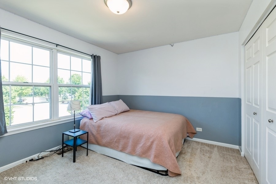 9675 Newton Road Huntley, IL 60142 - Photo 9 of 18 a bedroom with a bed and a window