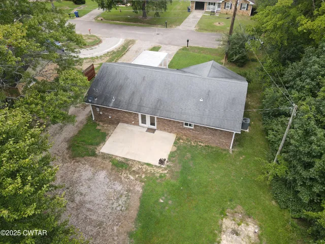 an aerial view of a house with yard