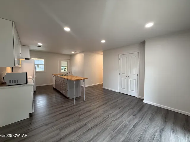 a room with a wooden floor and furniture