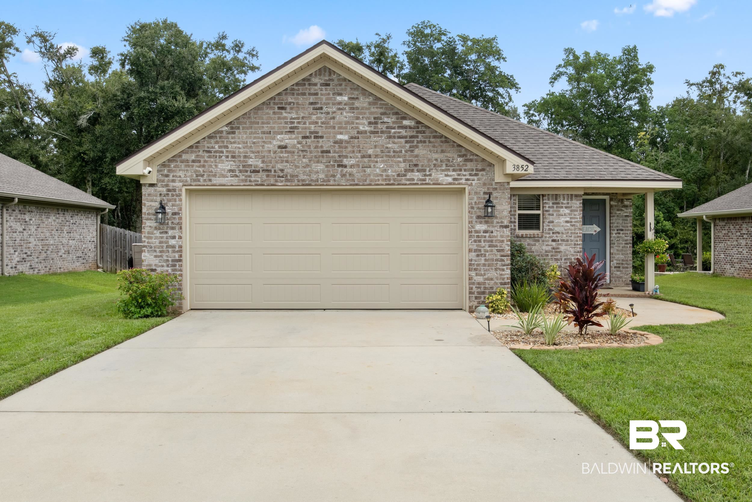 3852 Chesterfield Lane Foley, AL 36535 - Photo 3 of 34 View of front of house with a garage and a front lawn