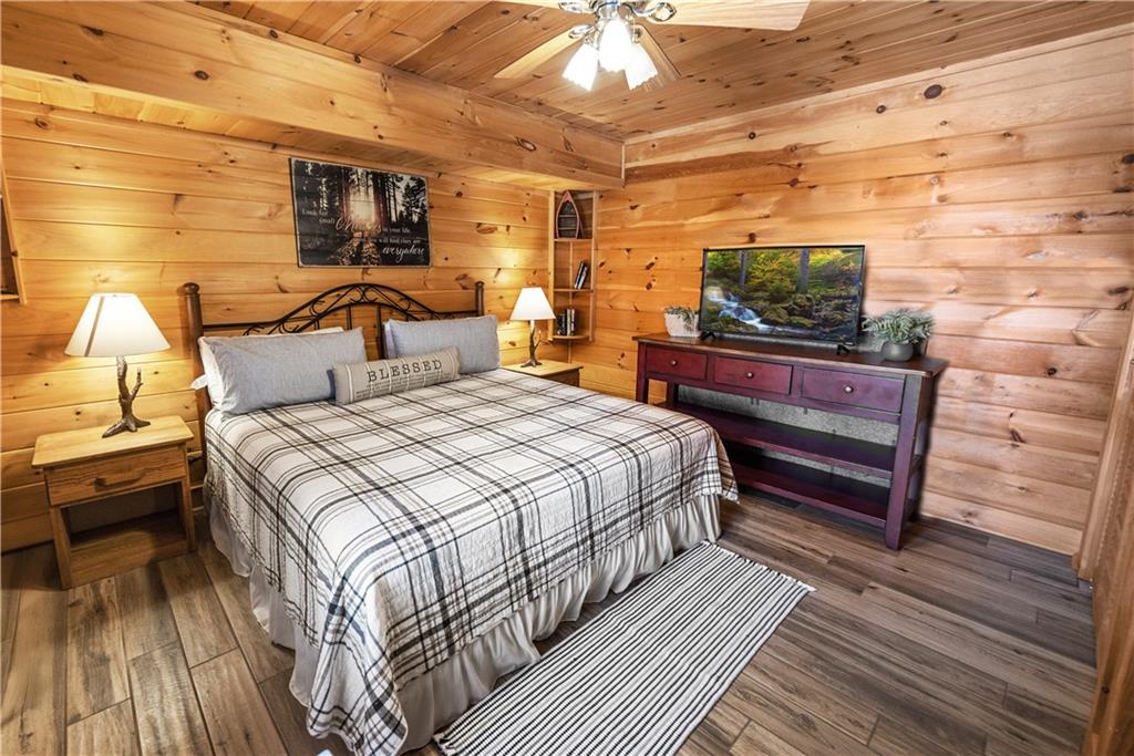 832 Scenic Mountain View Road Blue Ridge, GA 30513 - Photo 30 of 56 a bed room with a bed and a television