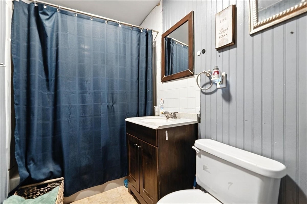 15 Kalmia Road Holbrook, MA 02343 - Photo 19 of 21 a bathroom with a sink a toilet and shower curtain