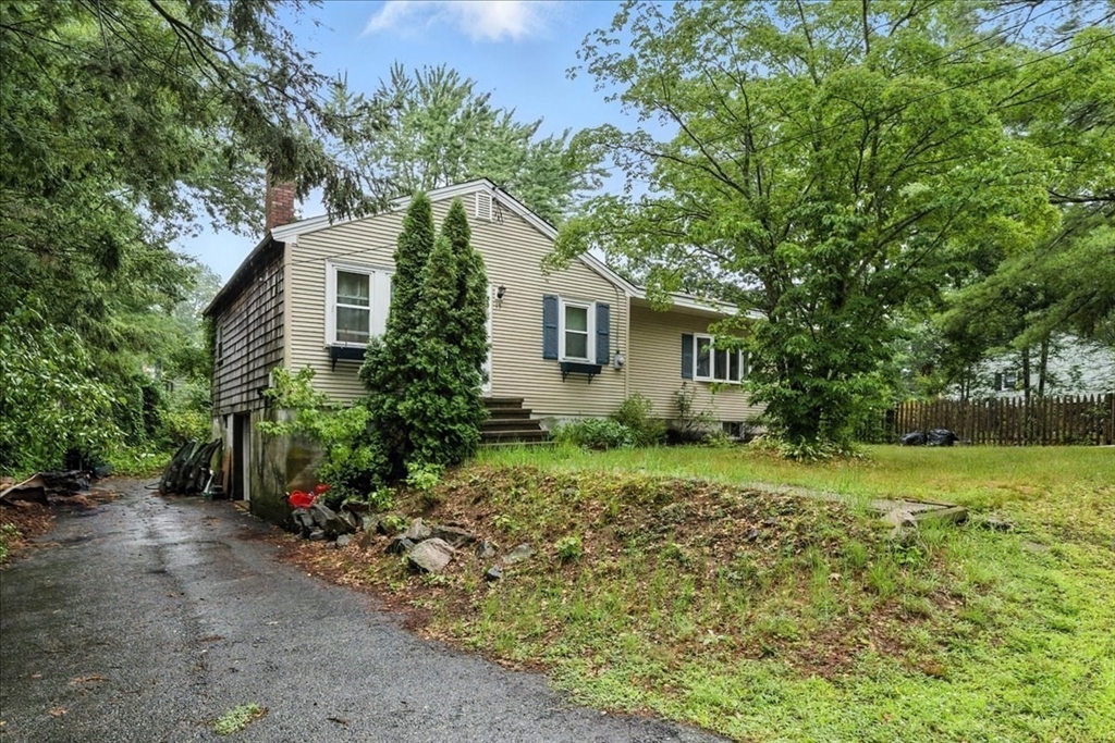 15 Kalmia Road Holbrook, MA 02343 - Photo 2 of 21 a yellow house with trees in front of it