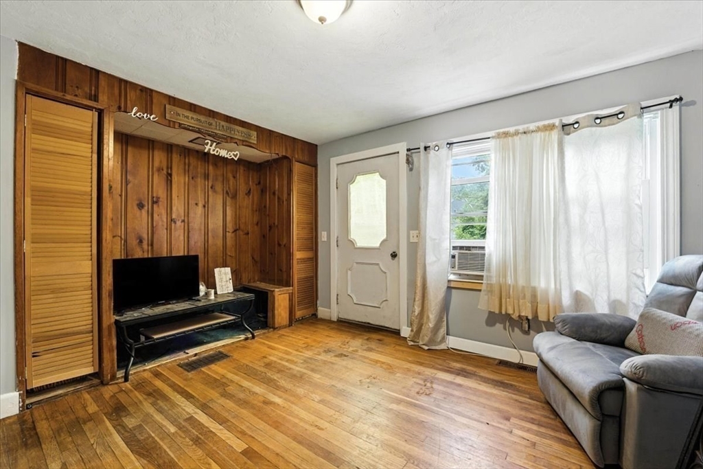 15 Kalmia Road Holbrook, MA 02343 - Photo 8 of 21 a living room with a couch a rug and a window