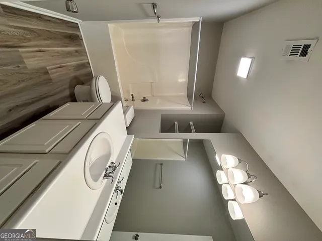 a bathroom with a sink and mirror