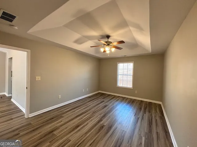wooden floor in an empty room with a window