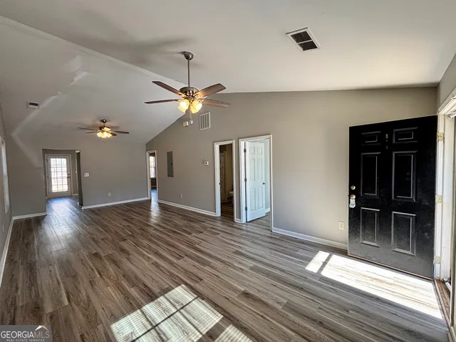 wooden floor in an empty room with a window