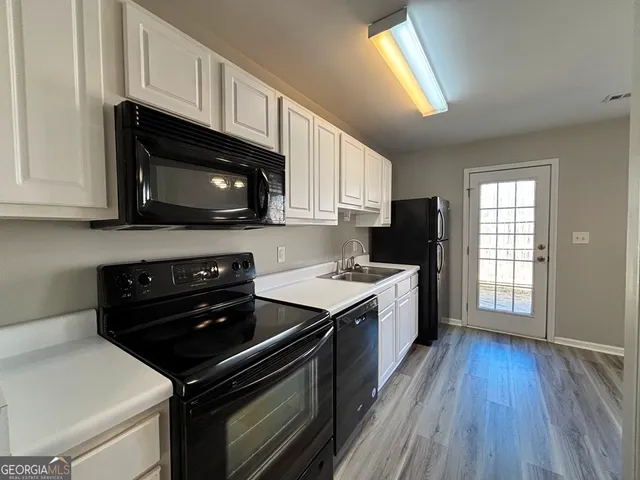 a kitchen with a stove and a microwave