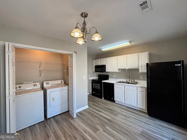 a kitchen with a stove a refrigerator and a stove top oven