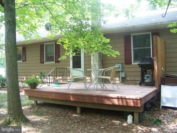6981 Breeding Road Federalsburg, MD 21632 - Photo 2 of 7 a view of house with backyard porch and sitting area