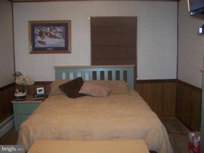6981 Breeding Road Federalsburg, MD 21632 - Photo 7 of 7 a bed sitting in a bedroom and painting on the wall