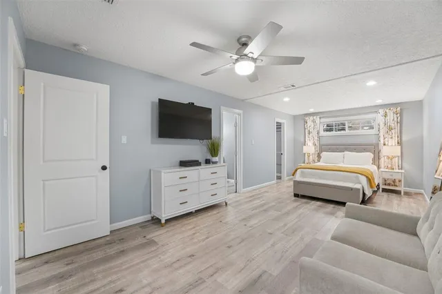 a hallway with a large window and fireplace
