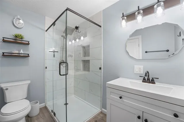 a bedroom with furniture and a flat screen tv