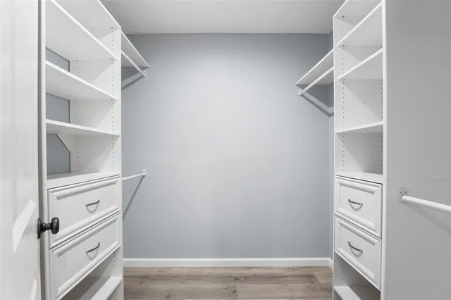 a bathroom with a toilet a sink a glass door shower and mirror