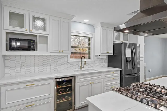 a kitchen with a refrigerator stove and sink