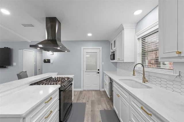a large kitchen with a table and chairs