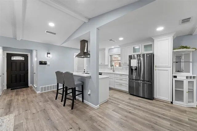 a kitchen with stainless steel appliances a sink stove and refrigerator