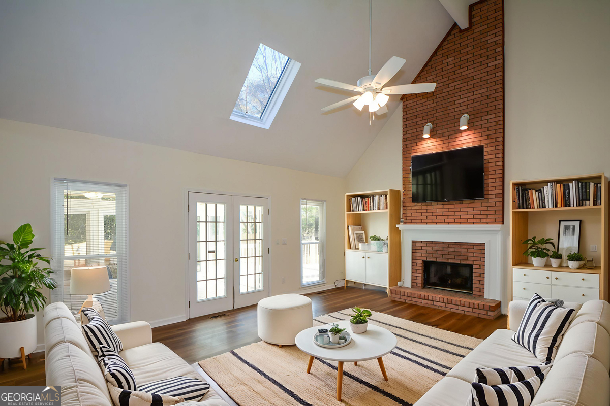 a living room with furniture a fireplace and a flat screen tv