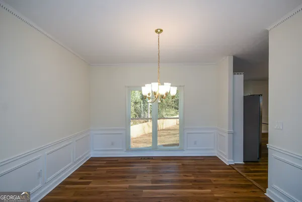 a view of a room with window and wooden floor
