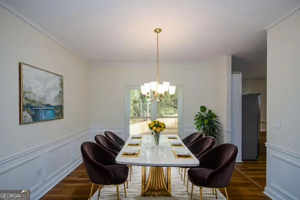 a dining room with furniture and window