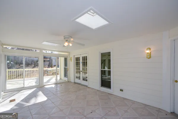 a view of an entryway with wooden floor and a fireplace