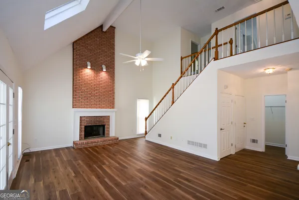 a living room with furniture a fireplace and a chandelier