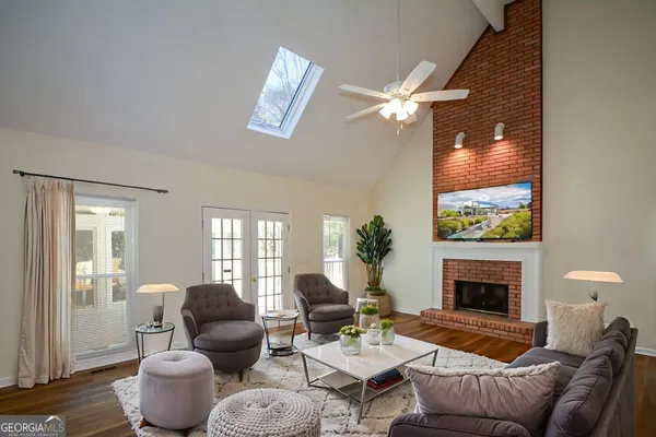 a view of staircase with wooden floor and white walls
