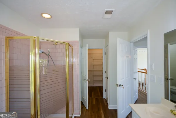 a view of an empty room with closet and a window