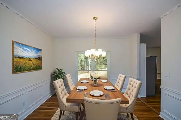 a view of a dining room with furniture and wooden floor