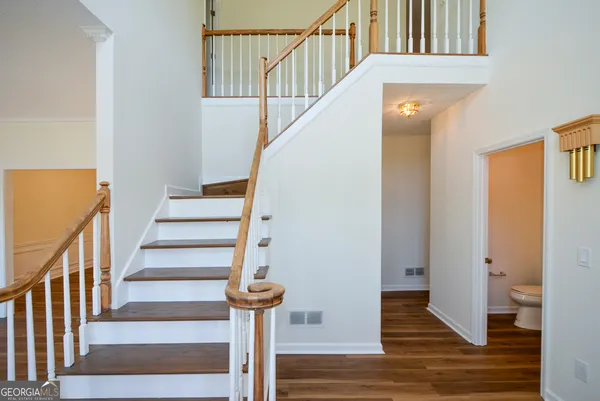 a view of entryway and hall with wooden floor