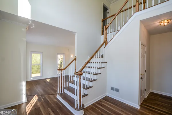 a view of entryway with wooden floor and stairs