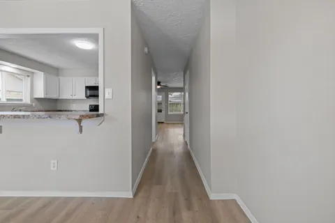 a view of hallway with wooden floor