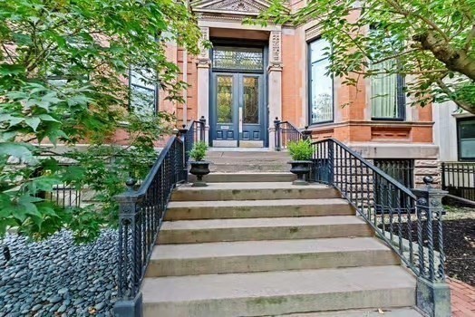 302 Commonwealth Avenue, Unit E Boston, MA 02115 - Photo 11 of 13 a view of a house with large windows and a tree