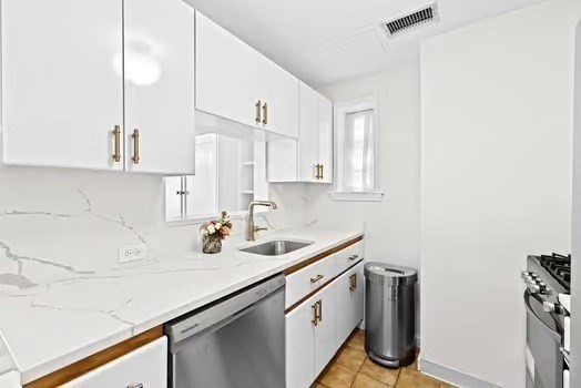 302 Commonwealth Avenue, Unit E Boston, MA 02115 - Photo 6 of 13 a kitchen with stainless steel appliances a sink a stove and a refrigerator