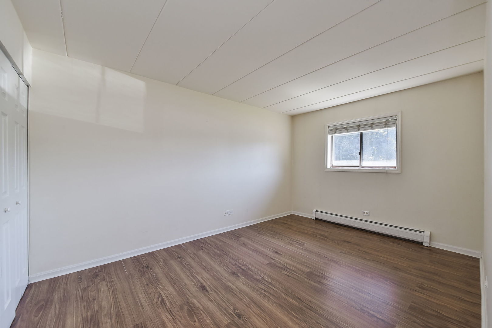 238 East Bailey Road, Unit G Naperville, IL 60565 - Photo 14 of 22 an empty room with wooden floor and windows