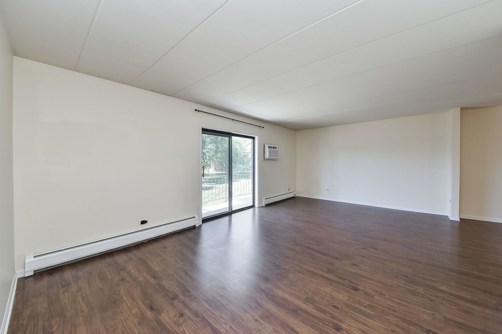238 East Bailey Road, Unit G Naperville, IL 60565 - Photo 2 of 22 a view of an empty room with wooden floor and a window