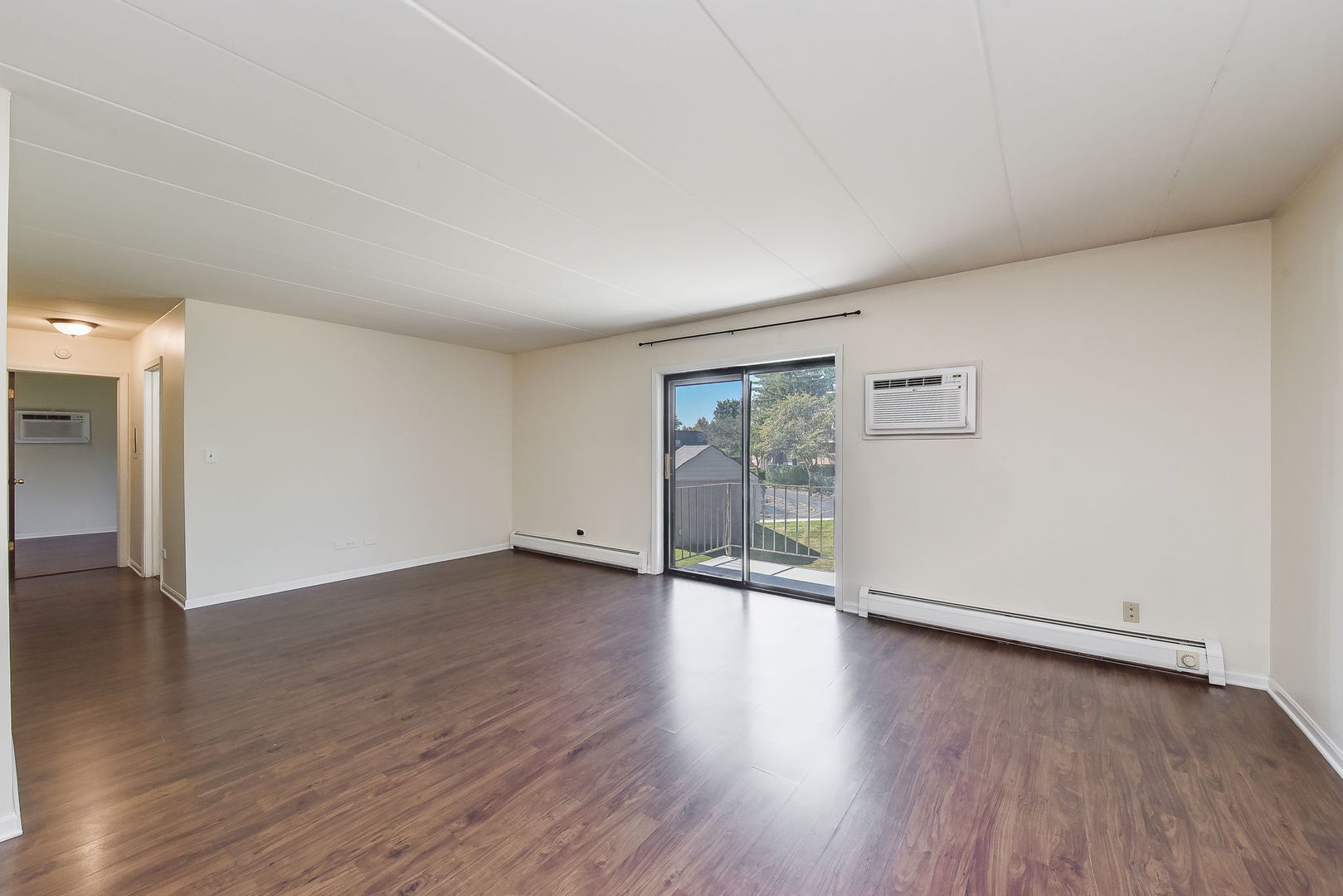 238 East Bailey Road, Unit G Naperville, IL 60565 - Photo 3 of 22 an empty room with wooden floor and windows