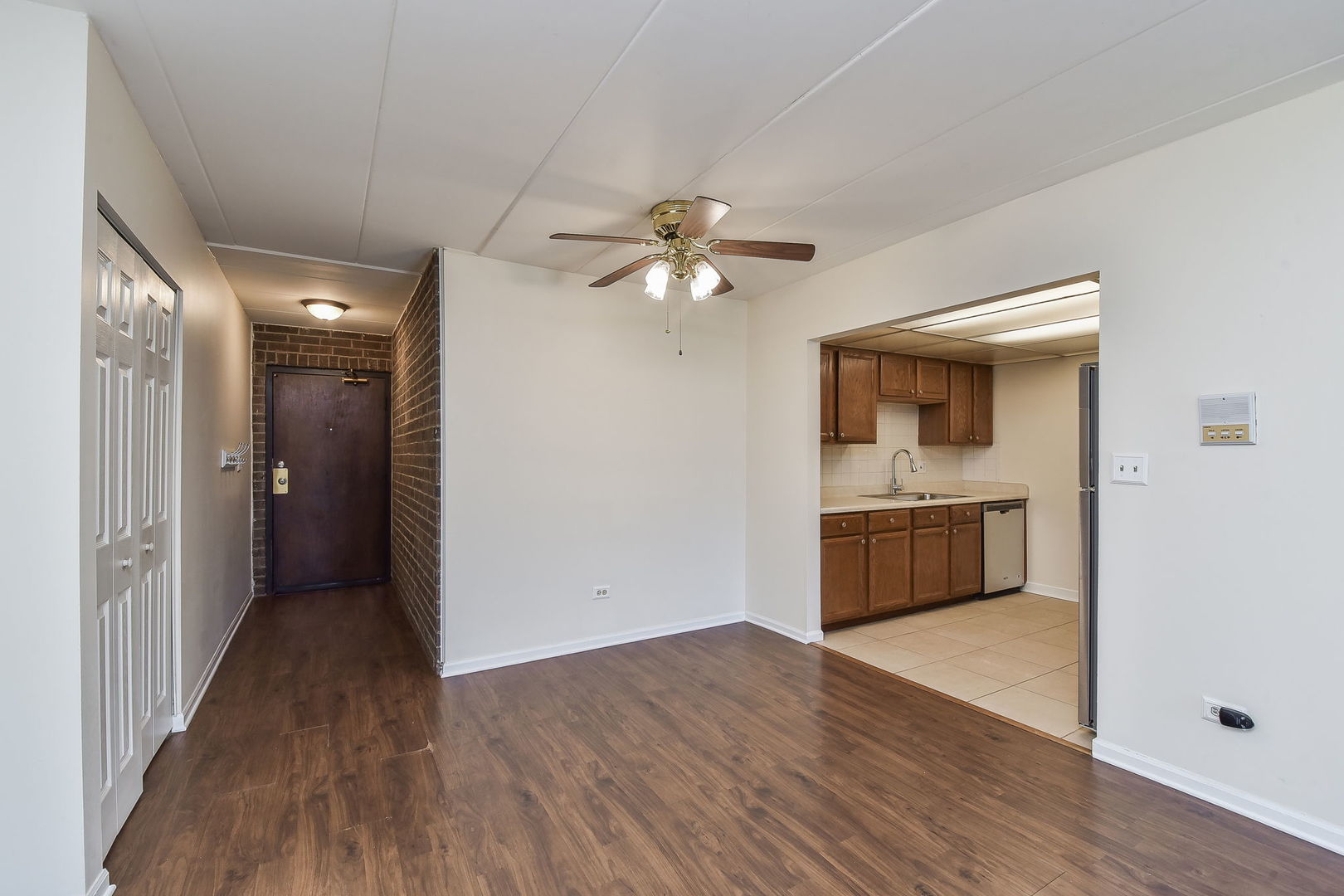 238 East Bailey Road, Unit G Naperville, IL 60565 - Photo 7 of 22 a view of a kitchen with a sink a kitchen island with wooden floor