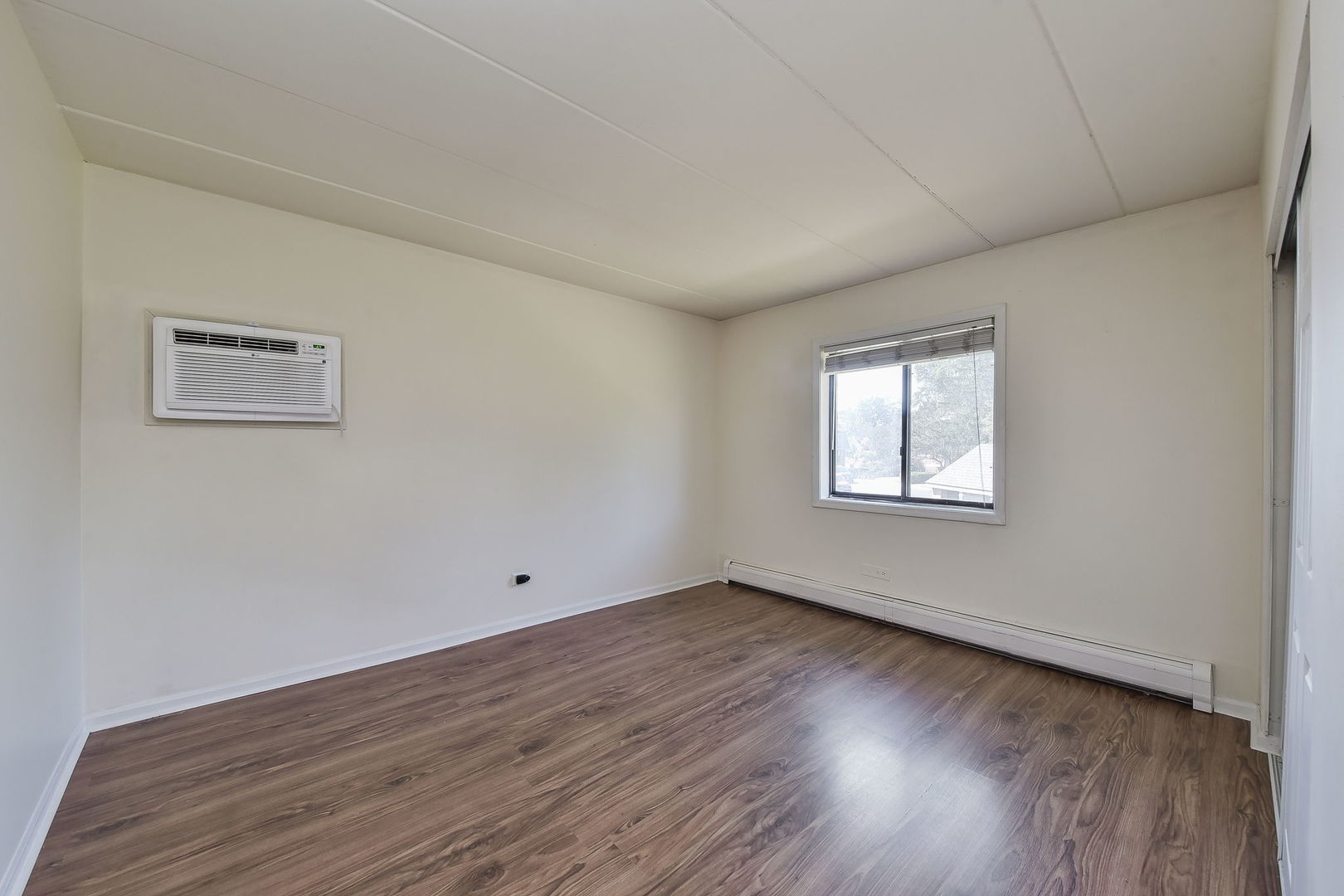238 East Bailey Road, Unit G Naperville, IL 60565 - Photo 10 of 22 a view of an empty room with wooden floor and a window