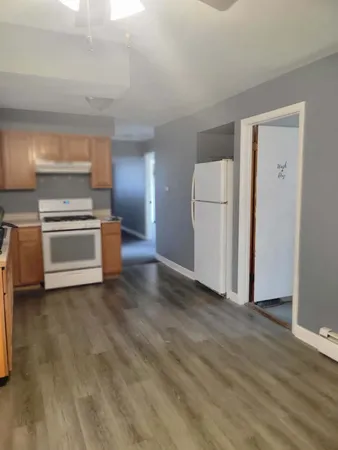 a kitchen with a sink a stove and cabinets