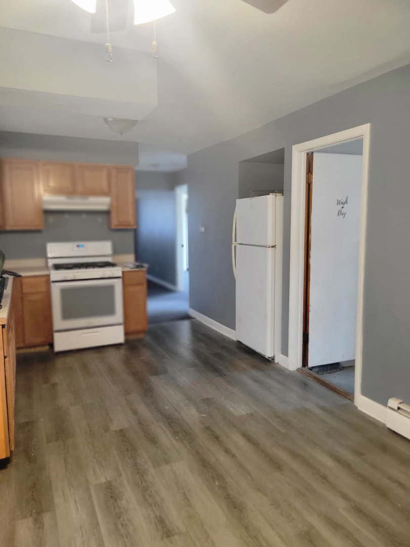 14652 Spaulding Avenue Harvey, IL 60426 - Photo 12 of 18 a view of a kitchen with a sink stove cabinets and empty room