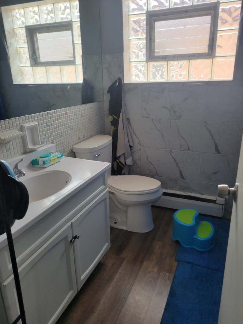 14652 Spaulding Avenue Harvey, IL 60426 - Photo 15 of 18 a bathroom with a sink toilet and window