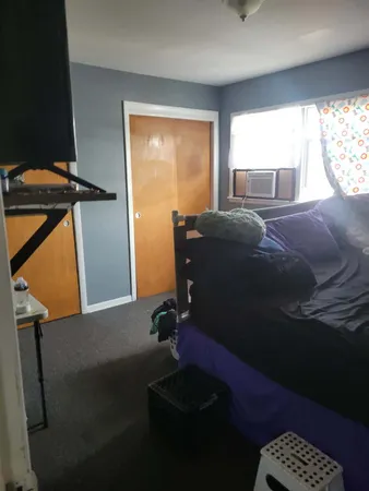 a bedroom with bed and a view of bathroom