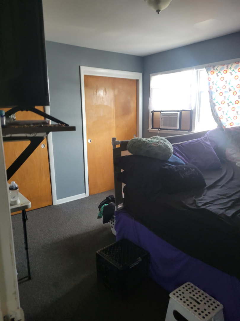 14652 Spaulding Avenue Harvey, IL 60426 - Photo 16 of 18 a bedroom with a bed and a window