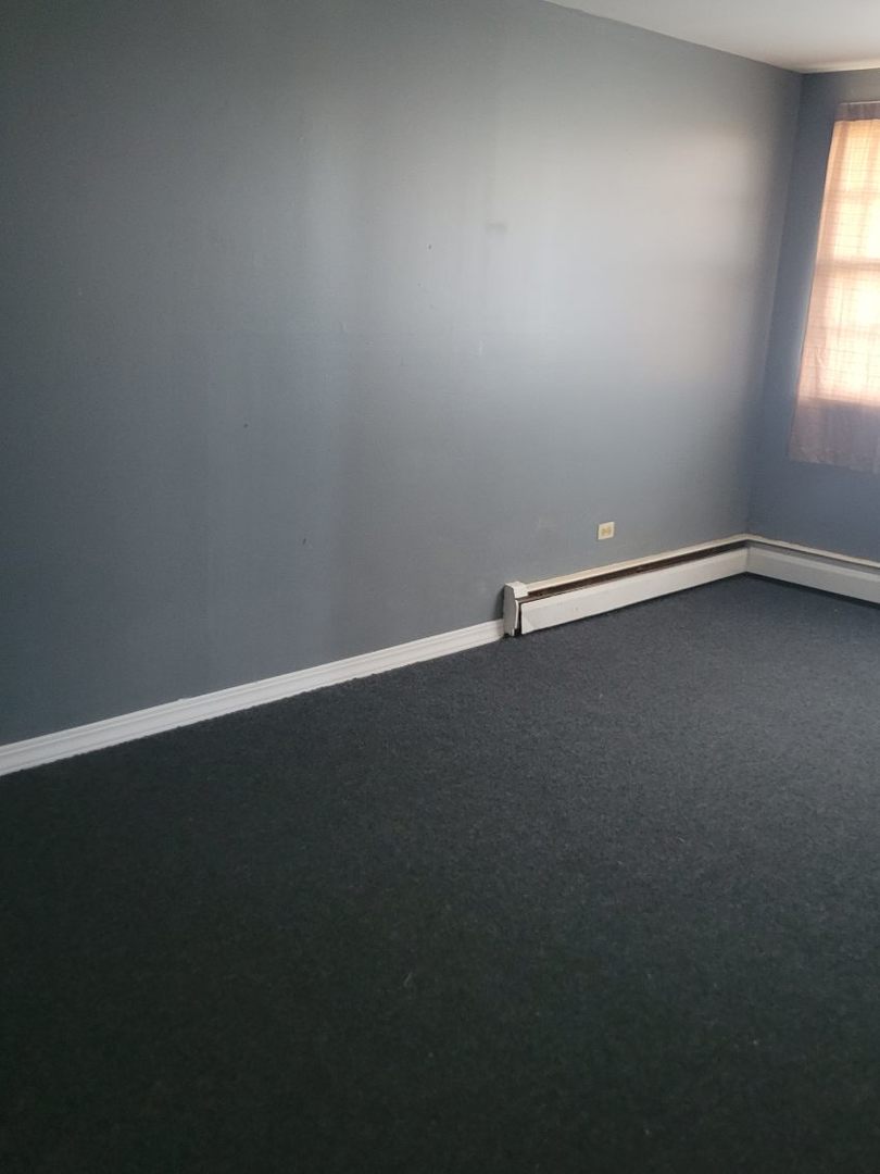 14652 Spaulding Avenue Harvey, IL 60426 - Photo 4 of 18 an empty room with a window