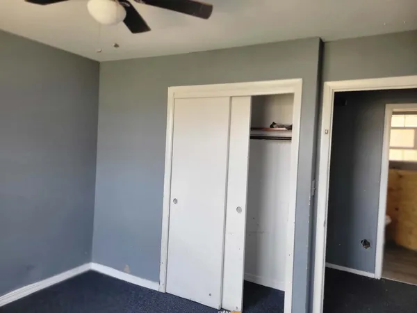 a view of kitchen with refrigerator and window