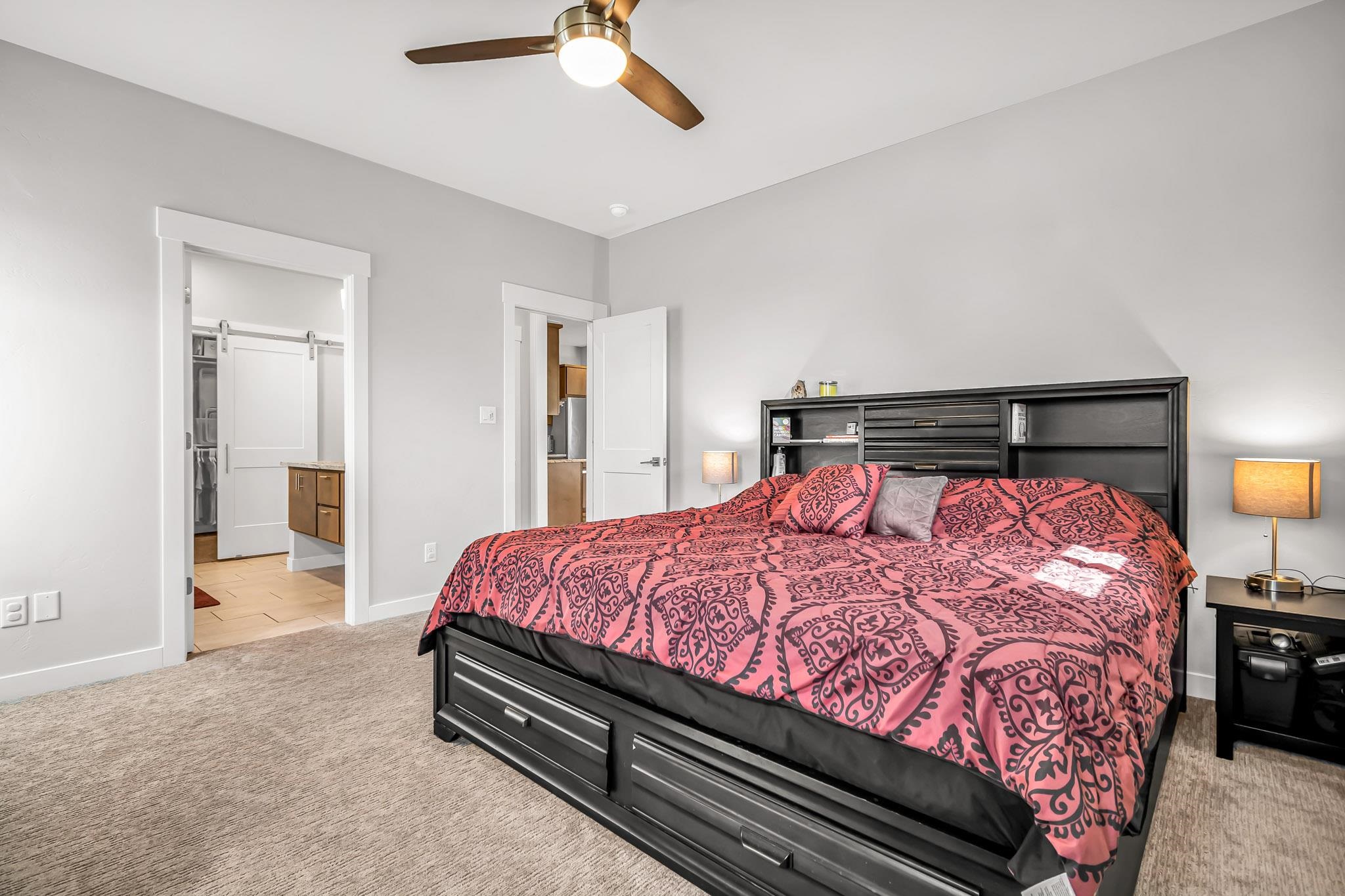 506 Grama Court Grand Junction, CO 81504 - Photo 15 of 28 a bedroom with a bed and a lamp