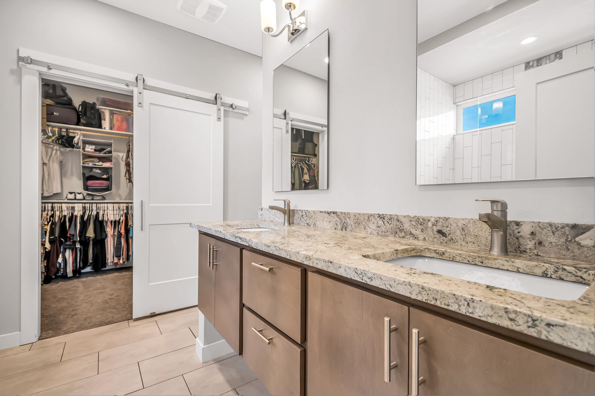 506 Grama Court Grand Junction, CO 81504 - Photo 16 of 28 a bathroom with a granite countertop sink and a mirror